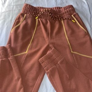 Fabletics Brown Sweatpants with Lime Green Trim.